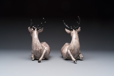 A pair of Chinese aubergine-glazed models of recumbent deer, 18/19th C.
