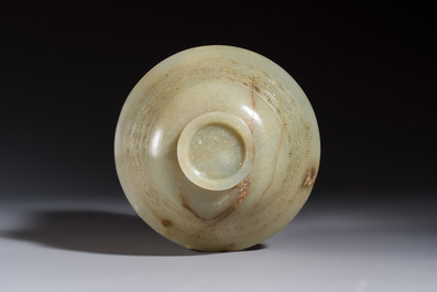 A Tibetan ritual jade bowl with a red coral-mounted silver cover and a stand, 19th C.