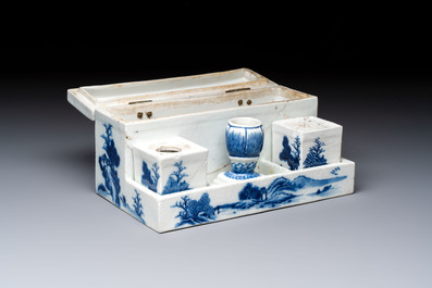 A Chinese blue and white 'Mountainous Landscape' writing set with an inkwell, sander and candlestick, Qianlong