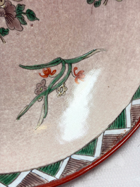 An unusual Chinese famille verte copper-red-ground shallow bowl with floral design, 19th C.
