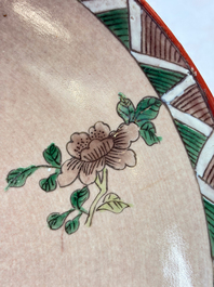 An unusual Chinese famille verte copper-red-ground shallow bowl with floral design, 19th C.