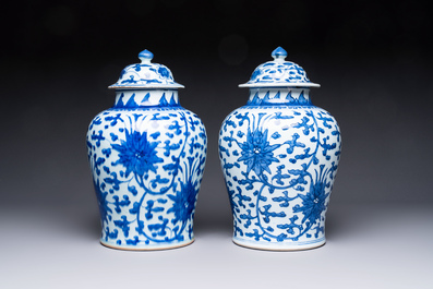 Two Chinese blue and white 'Lotus Scroll' vases and covers, Kangxi