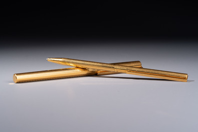 A gold-plated twist ballpoint pen and a fountain pen with an 18kt gold nib, S.T. Dupont Paris, France, 20th C.