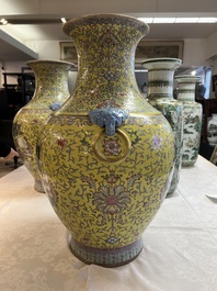 A pair of large Chinese famille rose yellow-ground 'Hu' vases with narrative design, Qianlong mark, Republic