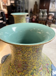 A pair of large Chinese famille rose yellow-ground 'Hu' vases with narrative design, Qianlong mark, Republic