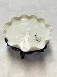 A Chinese Dehua blanc de Chine 'Lotus Leaf and Frog' brush washer on a wooden stand, Kangxi/Yongzheng