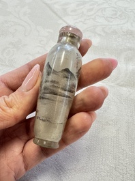 A Chinese inside-painted glass snuff bottle with two men wearing straw raincoats, dated 1911