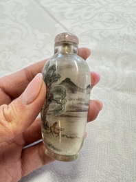 A Chinese inside-painted glass snuff bottle with two men wearing straw raincoats, dated 1911
