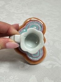 A pair of Chinese export famille rose lotus-form chambersticks on ruyi-shaped bases, Qianlong
