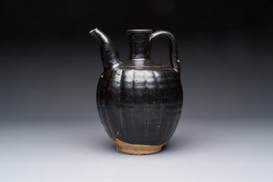 A Chinese Yaozhou black-glazed ewer with a ribbed body, Song