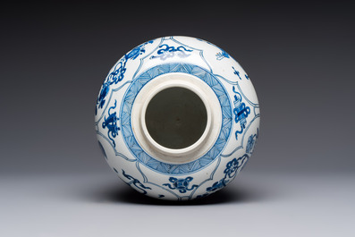 A Chinese blue and white 'Antiquities and Flower Baskets' vase with a wooden cover, Kangxi