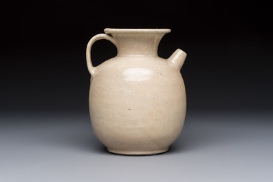 A Chinese cream-glazed ewer with a barrel-shaped body, Hebei/Henan provinces, Tang/Five Dynasties