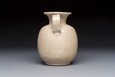 A Chinese cream-glazed ewer with a barrel-shaped body, Hebei/Henan provinces, Tang/Five Dynasties