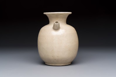 A Chinese cream-glazed ewer with a barrel-shaped body, Hebei/Henan provinces, Tang/Five Dynasties