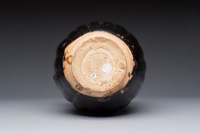 A Chinese Yaozhou black-glazed ewer with a ribbed body, Song