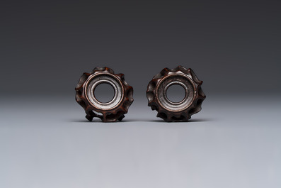A pair of Chinese bird feeders with moulded design, one unglazed, on later wooden stands, Song