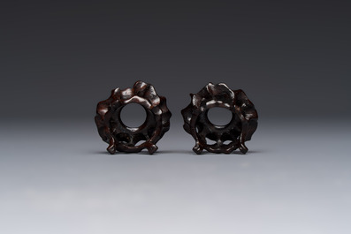 A pair of Chinese bird feeders with moulded design, one unglazed, on later wooden stands, Song