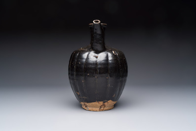 A Chinese Yaozhou black-glazed ewer with a ribbed body, Song