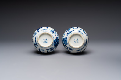 A pair of Chinese blue and white 'Buddhist Lions' triple gourd vases on reticulated wooden stands, 19th C.