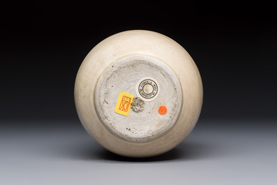 A Chinese cream-glazed ewer with a barrel-shaped body, Hebei/Henan provinces, Tang/Five Dynasties