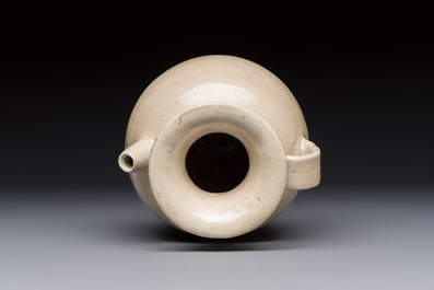 A Chinese cream-glazed ewer with a barrel-shaped body, Hebei/Henan provinces, Tang/Five Dynasties