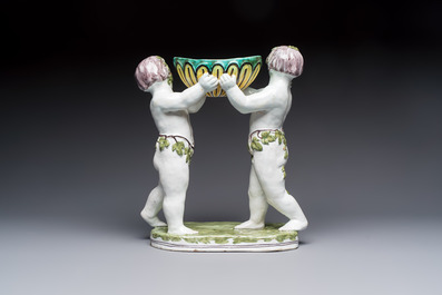 A French polychrome faience group with two Bacchus figures, Geo Martel, D&egrave;svres, early 20th C.