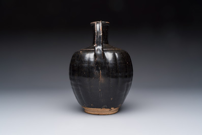A Chinese Yaozhou black-glazed ewer with a ribbed body, Song