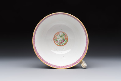 A Chinese Canton famille rose cup and saucer with figures in a garden, 19th C.