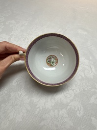 A Chinese Canton famille rose cup and saucer with figures in a garden, 19th C.