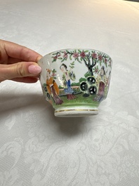 A Chinese Canton famille rose cup and saucer with figures in a garden, 19th C.