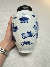 A Chinese blue and white ovoid 'Antiquities' jar with a wooden cover, Kangxi