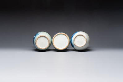 Two Chinese blue and white celadon-ground vases and a blue and white vase, on wooden stands, 19th C.
