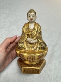 A Japanese Satsuma figure of Buddha seated on a lotus base, Hododa 保土田 mark, Meiji, 19/20th C.