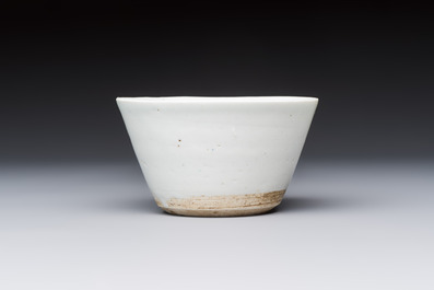 A Chinese white-glazed cup on a wooden stand, 17th C.