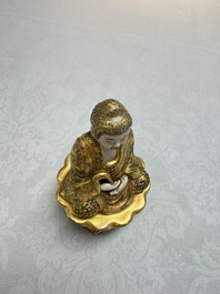 A Japanese Satsuma figure of Buddha seated on a lotus base, Hododa 保土田 mark, Meiji, 19/20th C.