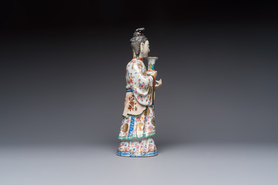 A Chinese famille rose candle holder in the shape of a court lady holding a 'Gu' vase, Qianlong
