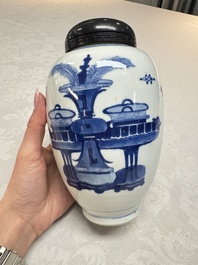 A Chinese blue and white ovoid 'Antiquities' jar with a wooden cover, Kangxi
