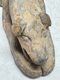 A Chinese grey pottery model of a reclining dog, Han