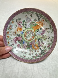 A Chinese Canton famille rose cup and saucer with figures in a garden, 19th C.