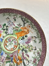 A Chinese Canton famille rose cup and saucer with figures in a garden, 19th C.