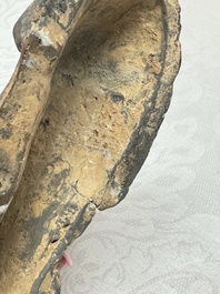 A Chinese grey pottery model of a reclining dog, Han