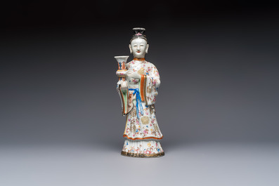 A Chinese famille rose candle holder in the shape of a court lady holding a 'Gu' vase, Qianlong