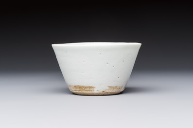 A Chinese white-glazed cup on a wooden stand, 17th C.