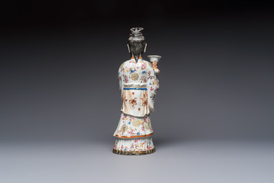 A Chinese famille rose candle holder in the shape of a court lady holding a 'Gu' vase, Qianlong