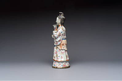 A Chinese famille rose candle holder in the shape of a court lady holding a 'Gu' vase, Qianlong