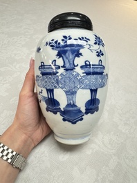 A Chinese blue and white ovoid 'Antiquities' jar with a wooden cover, Kangxi