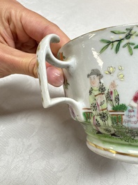 A Chinese Canton famille rose cup and saucer with figures in a garden, 19th C.