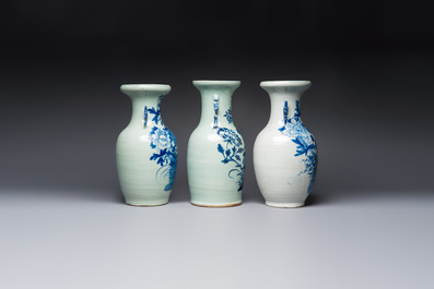 Two Chinese blue and white celadon-ground vases and a blue and white vase, on wooden stands, 19th C.