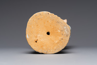 A Chinese famille rose candle holder in the shape of a court lady holding a 'Gu' vase, Qianlong