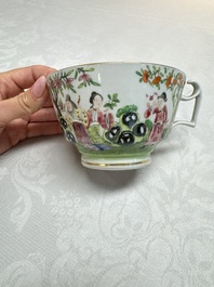 A Chinese Canton famille rose cup and saucer with figures in a garden, 19th C.